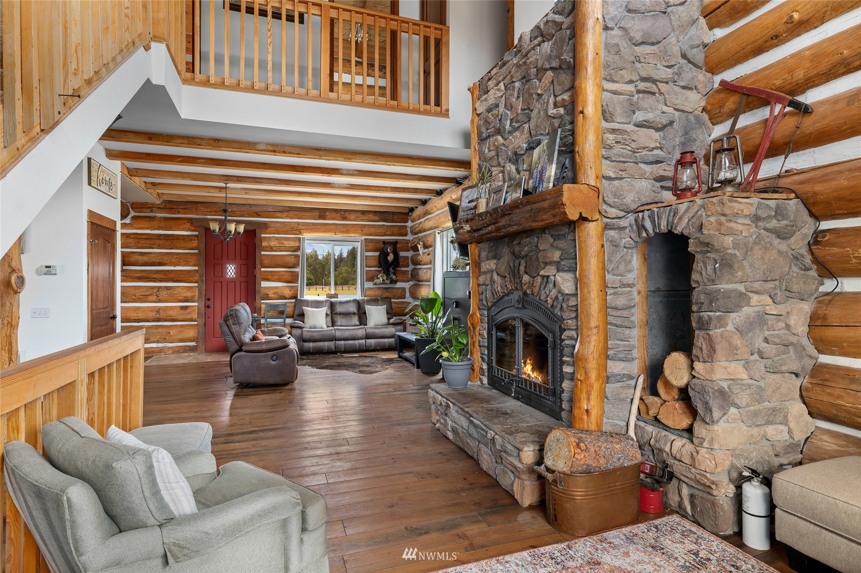 170 Quail Valley Road Cle Elum, WA 98922 - Photo 8 of 40 a living room with furniture a fireplace and a floor to ceiling window