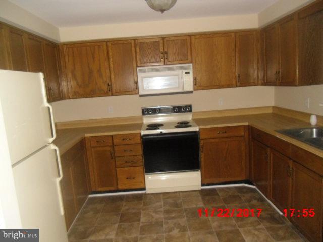 30858 Rabbit Hill Road Cordova, MD 21625 - Photo 4 of 8 a kitchen with a sink stove and cabinets