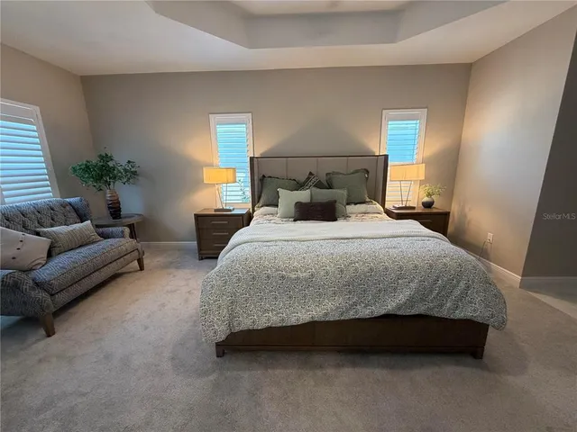 a spacious bedroom with a bed and a couch