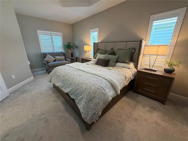 a bed sitting in a bedroom next to a window