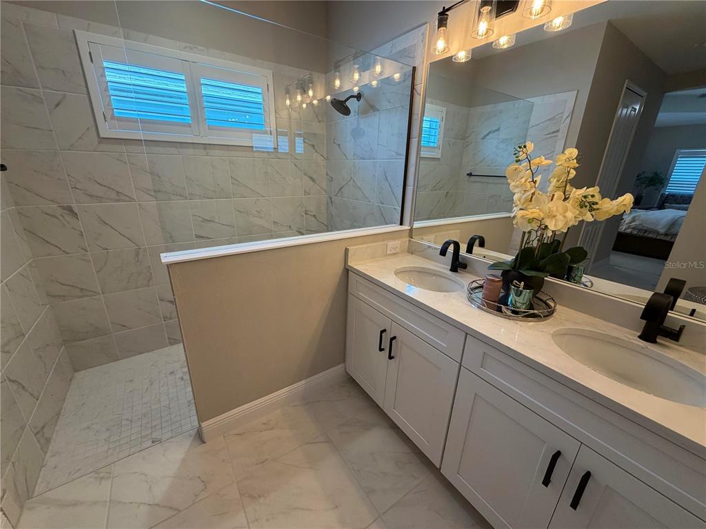 10710 Falling Leaf Court Parrish, FL 34219 - Photo 19 of 28 a bathroom with a sink a vanity and a mirror