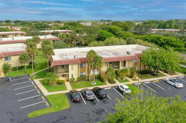 an aerial view of a house with swimming pool garden and patio