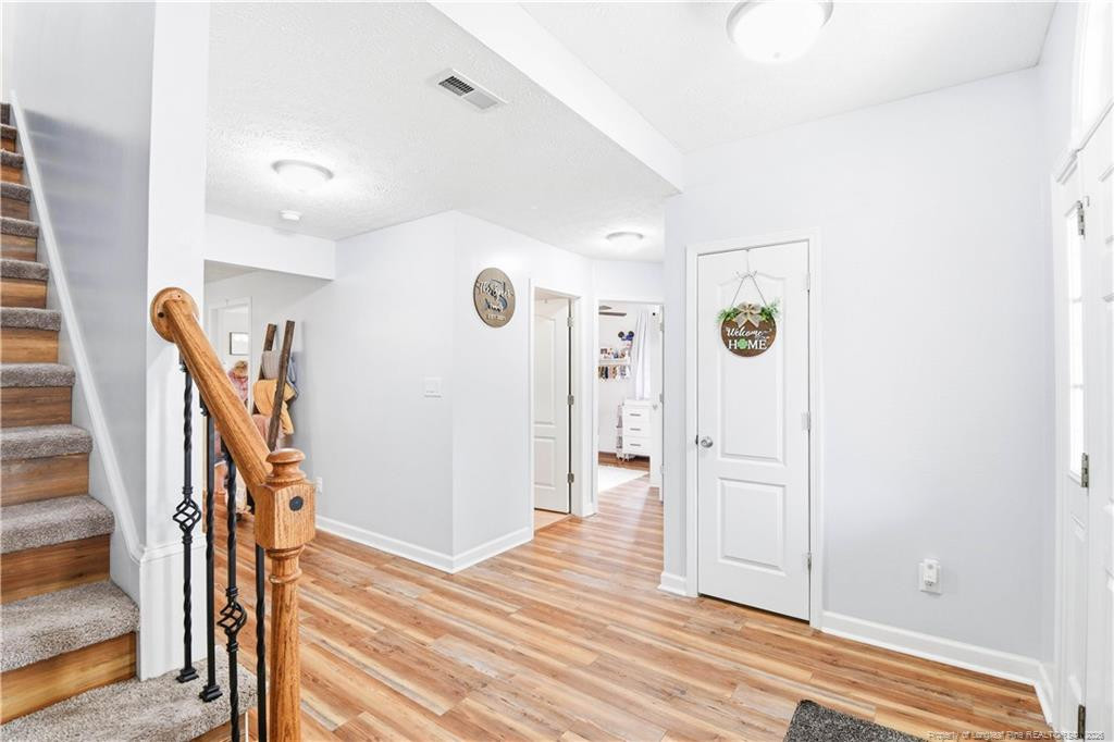 212 Lennox Loop Raeford, NC 28376 - Photo 18 of 47 a view of a hallway with wooden floor and staircase