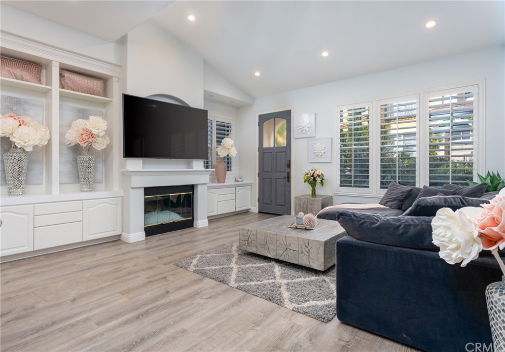 a living room with fireplace furniture and a flat screen tv