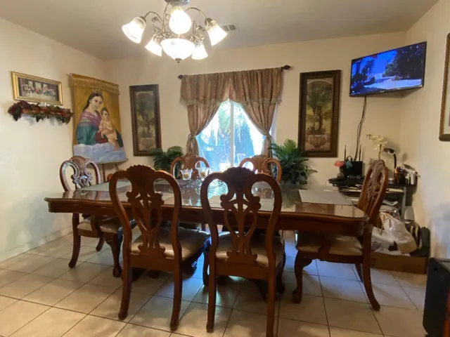 a dining room with furniture and window