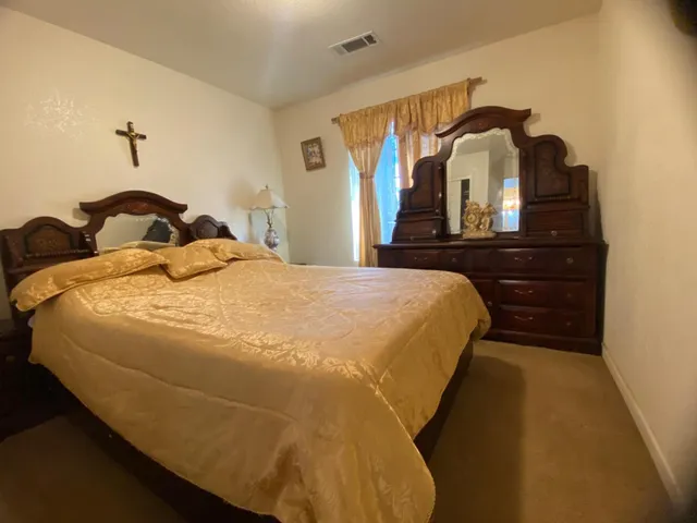 a bedroom with a bed and dresser