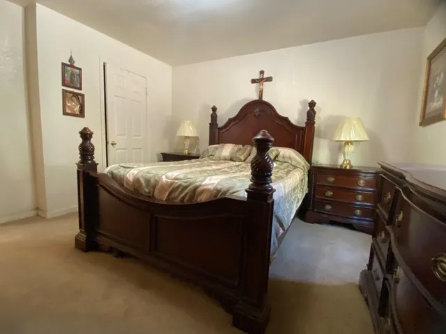 a bed sitting in a bedroom next to a window