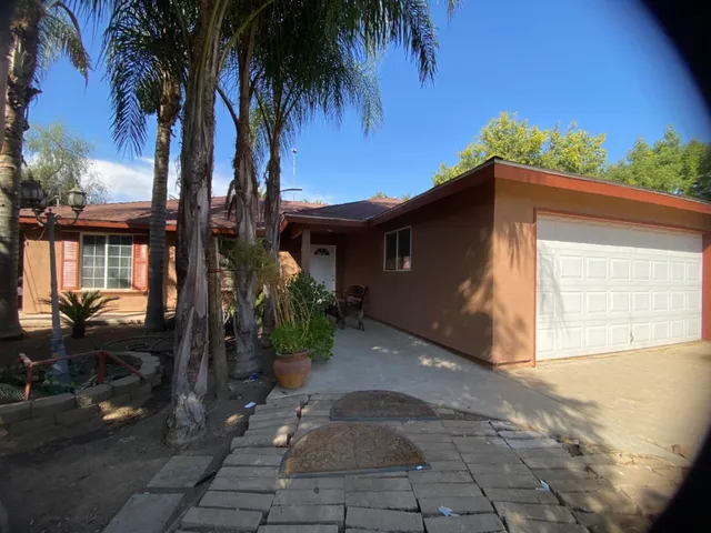 a backyard of a house with potted plants
