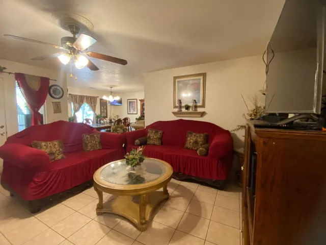 a living room with furniture and a chandelier