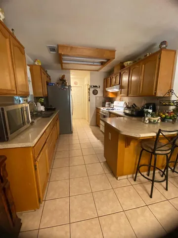a kitchen with a sink appliances and cabinets