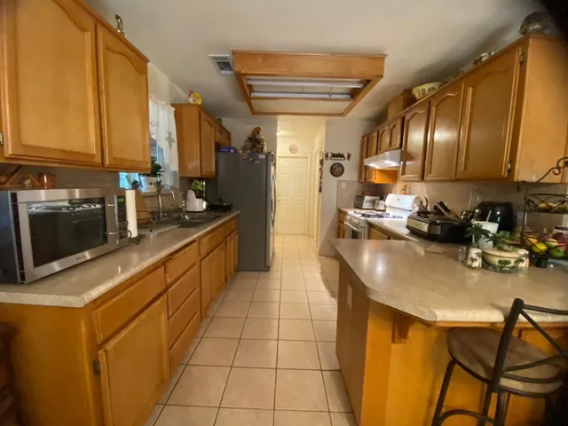 a kitchen with a sink appliances and cabinets