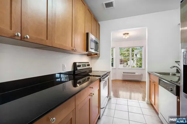 a kitchen with a sink a stove and cabinets
