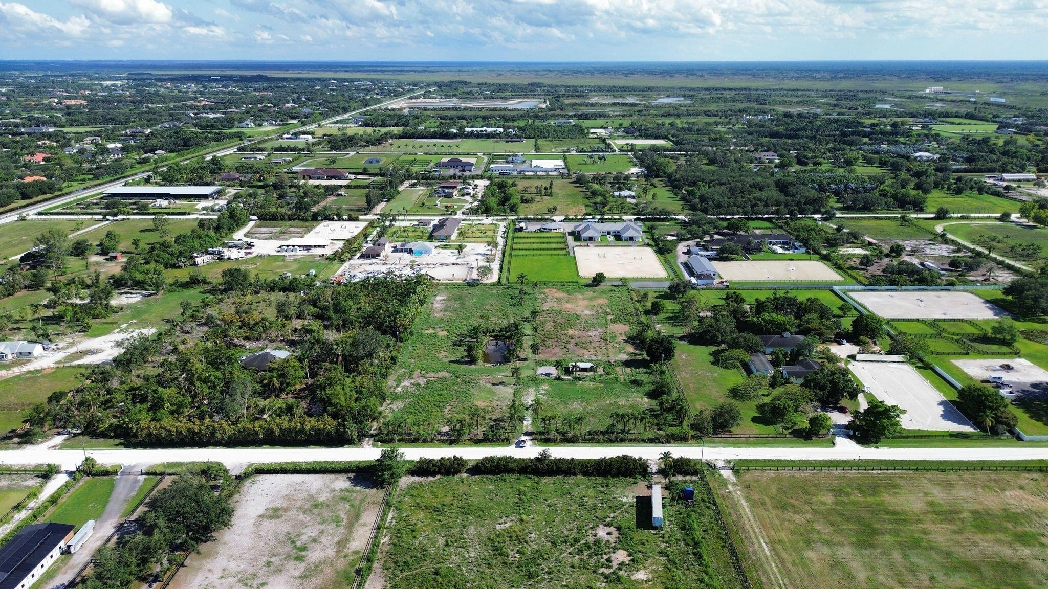 16290 Rustic Road Wellington, FL 33470 - Photo 5 of 20 an aerial view of residential houses with outdoor space and swimming pool