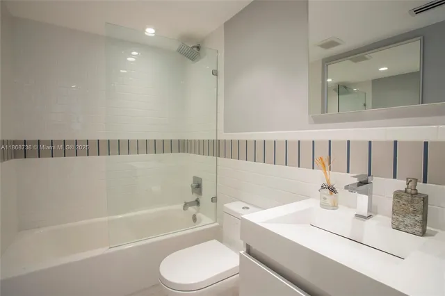 a bathroom with a sink a toilet and bathtub