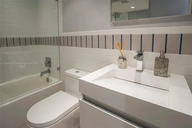 a bathroom with a sink a toilet and vanity