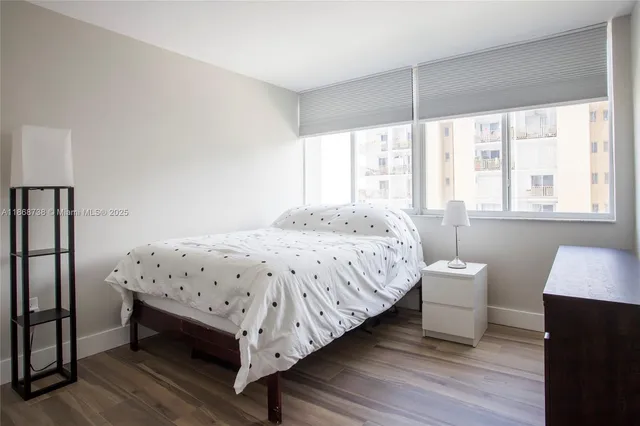 a bedroom with a bed table and a window
