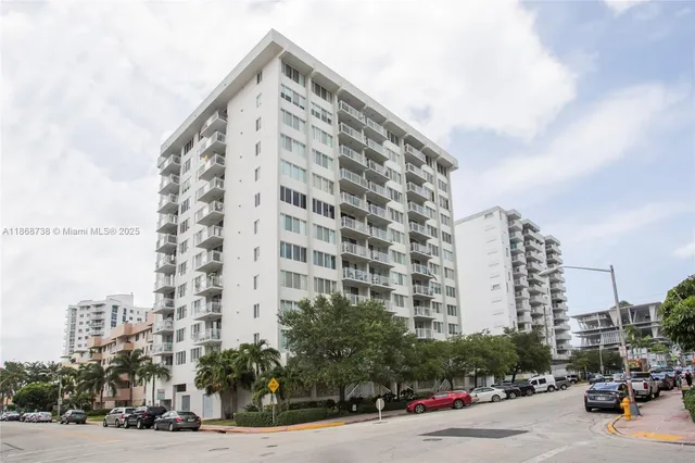a city street with tall buildings in the background