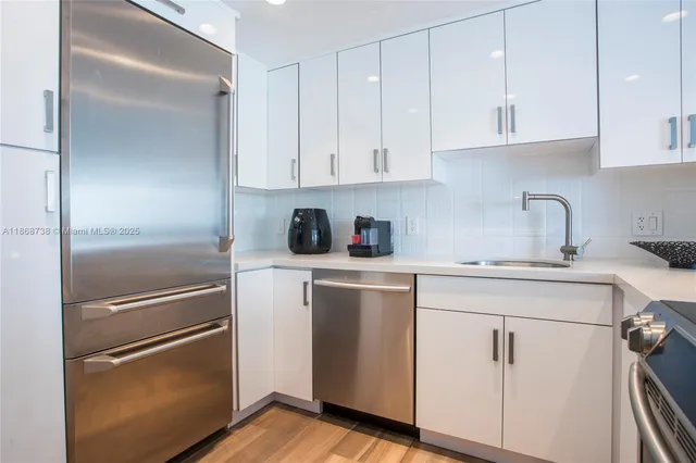 a kitchen with white cabinets and white appliances