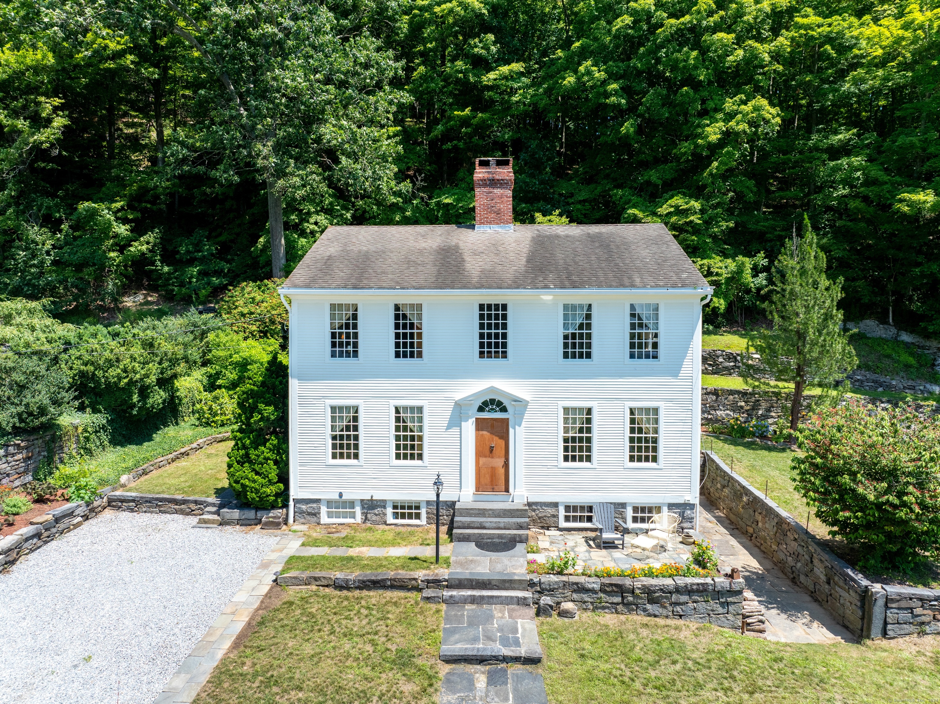 12 Landing Hill Road Chester, CT 06412 - Photo 1 of 1 a front view of a house with a yard table and chairs