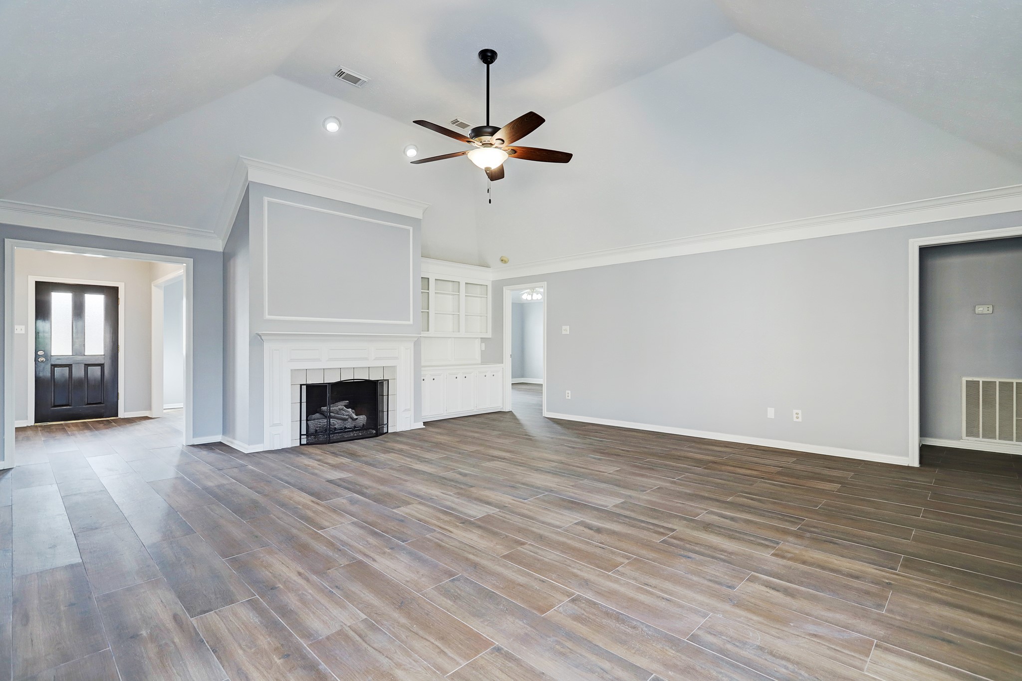 7403 Manor Bridge Court Houston, TX 77095 - Photo 4 of 11 a view of empty room with wooden floor fireplace and window