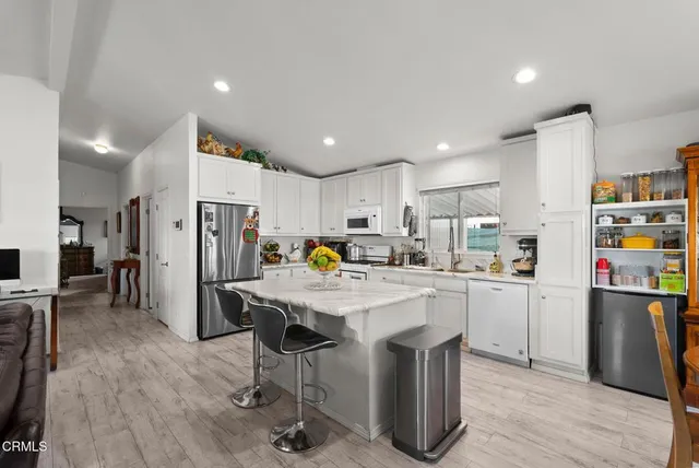 a kitchen with refrigerator and cabinets