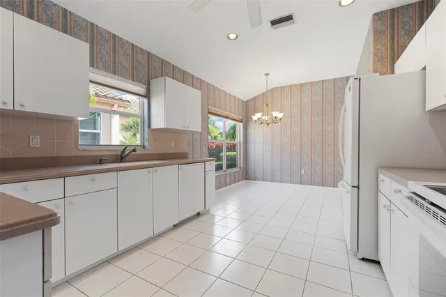 a kitchen with a sink cabinets and window