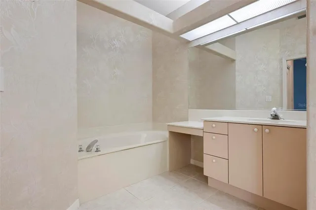 a spacious bathroom with a granite countertop sink mirror and toilet