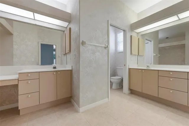 a bathroom with a double vanity sink and mirror