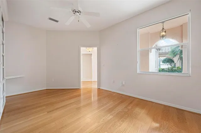 a view of a room with window and a white ceiling fan