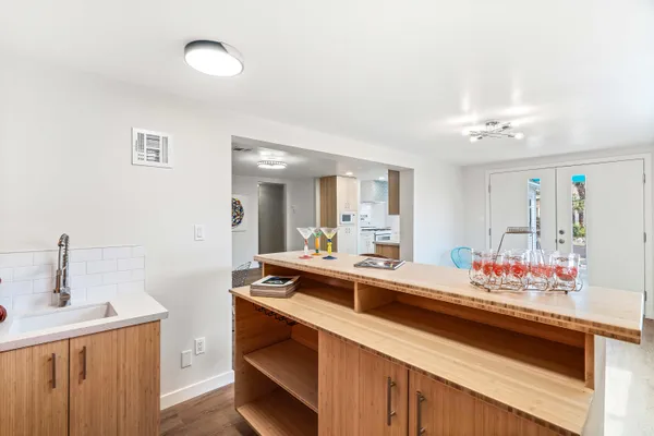a kitchen with stainless steel appliances a stove a sink and a refrigerator