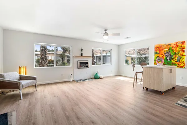 a living room with furniture a table and wooden floor
