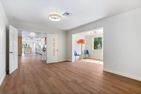 a view of empty room with wooden floor