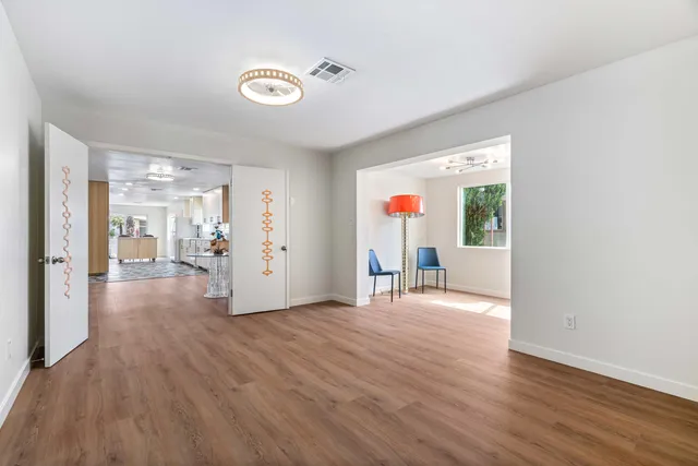 a view of empty room with wooden floor