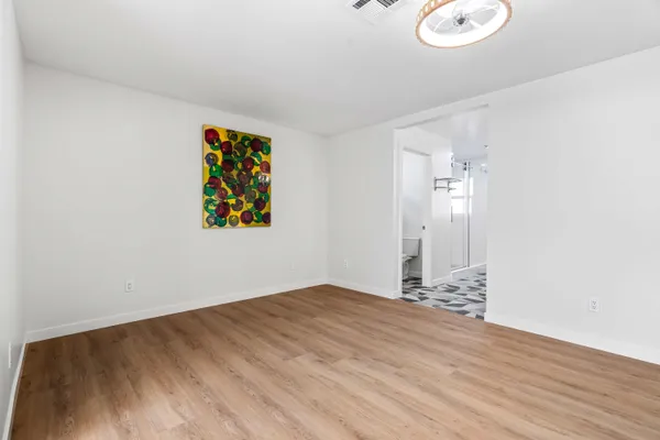 a view of a room with wooden floor and windows