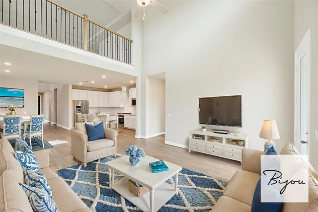 a living room with furniture a rug and a flat screen tv