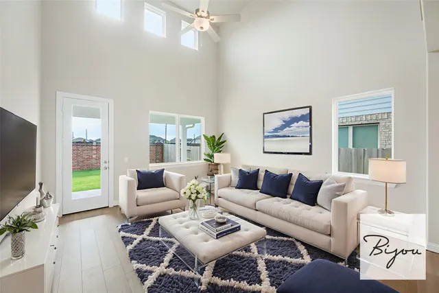 a living room with furniture a rug and a flat screen tv