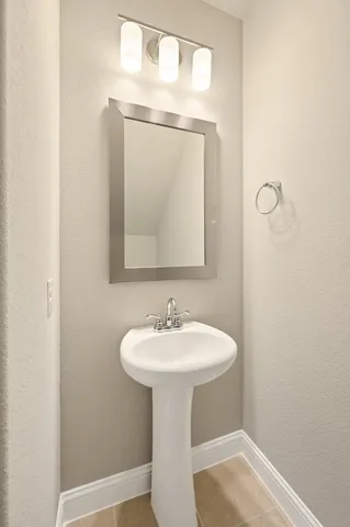 a bathroom with a sink a mirror and vanity