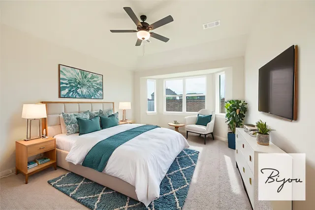 a bedroom with a large bed and a flat screen tv