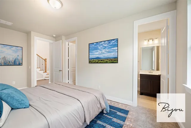 a bedroom with a bed and a painting on the wall