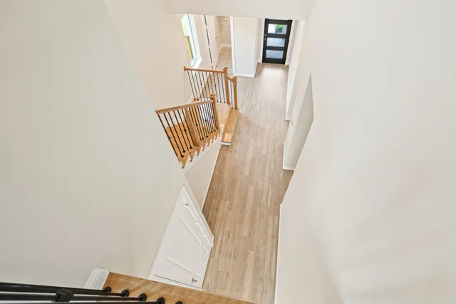a spacious bedroom with a large bed and a potted plant