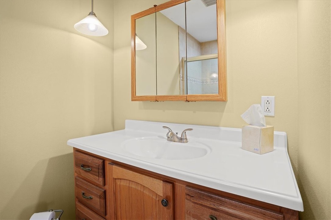 1845 Robalo Drive, Unit 201D Vero Beach, FL 32960 - Photo 17 of 35 a bathroom with a sink and a mirror
