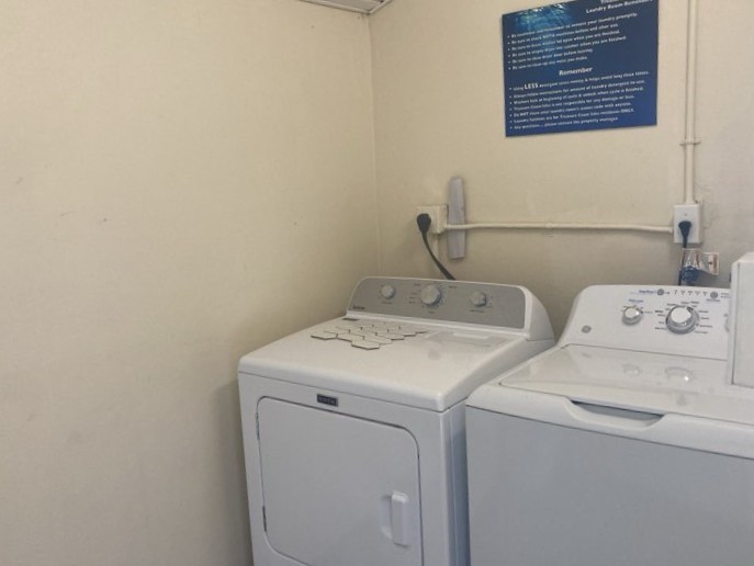 1845 Robalo Drive, Unit 201D Vero Beach, FL 32960 - Photo 22 of 35 a utility room with dryer and washer