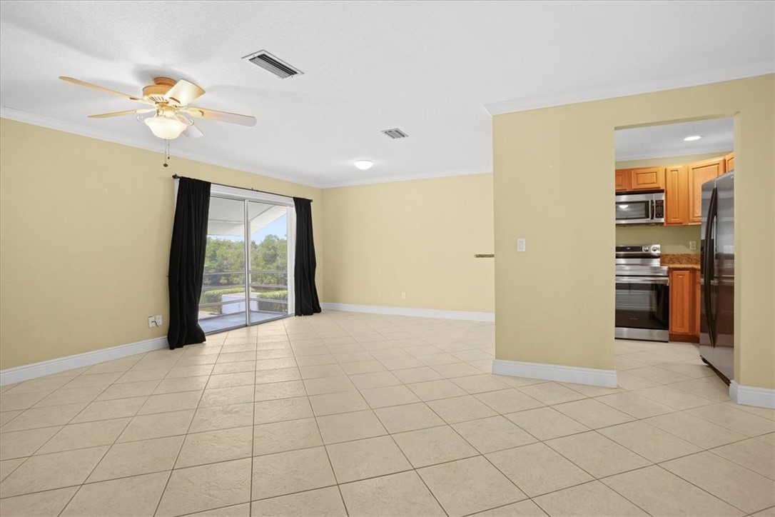 1845 Robalo Drive, Unit 201D Vero Beach, FL 32960 - Photo 5 of 35 a view of an empty room with window and cabinet