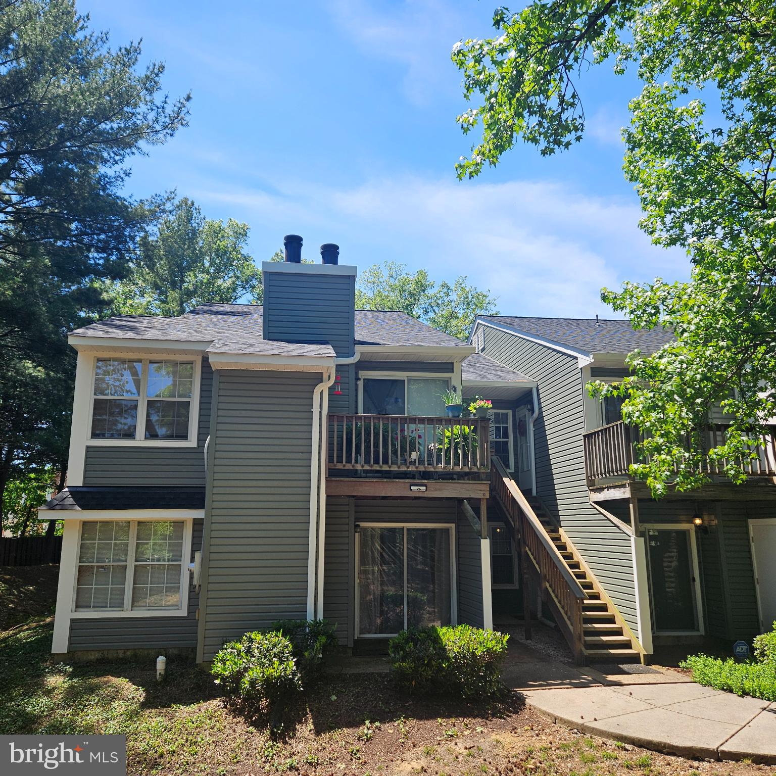 8637 D Beekman Place, Unit 37D Alexandria, VA 22309 - Photo 15 of 18 a front view of a house with a garden