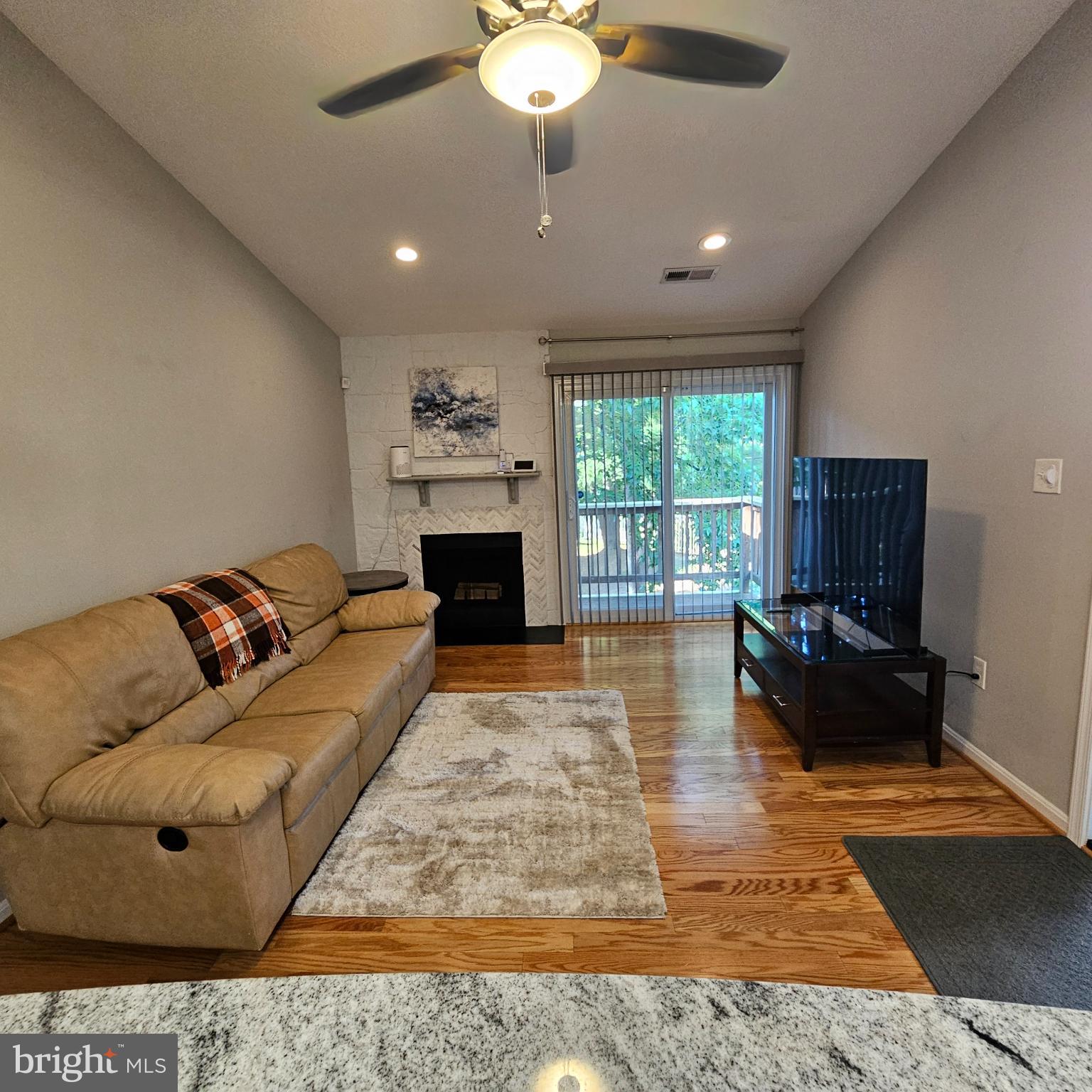 8637 D Beekman Place, Unit 37D Alexandria, VA 22309 - Photo 4 of 18 a living room with furniture and a fireplace
