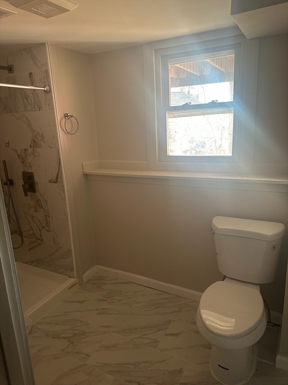 4 Gallagher Drive, Unit 1 Randolph, MA 02368 - Photo 8 of 9 a bathroom with a toilet and a shower