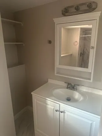 a bathroom with a sink a vanity and a toilet