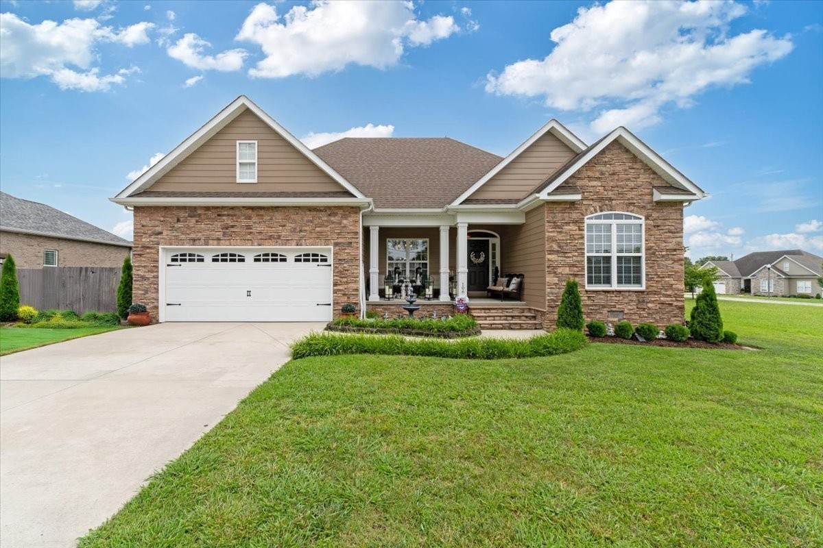 a front view of a house with a yard and garage