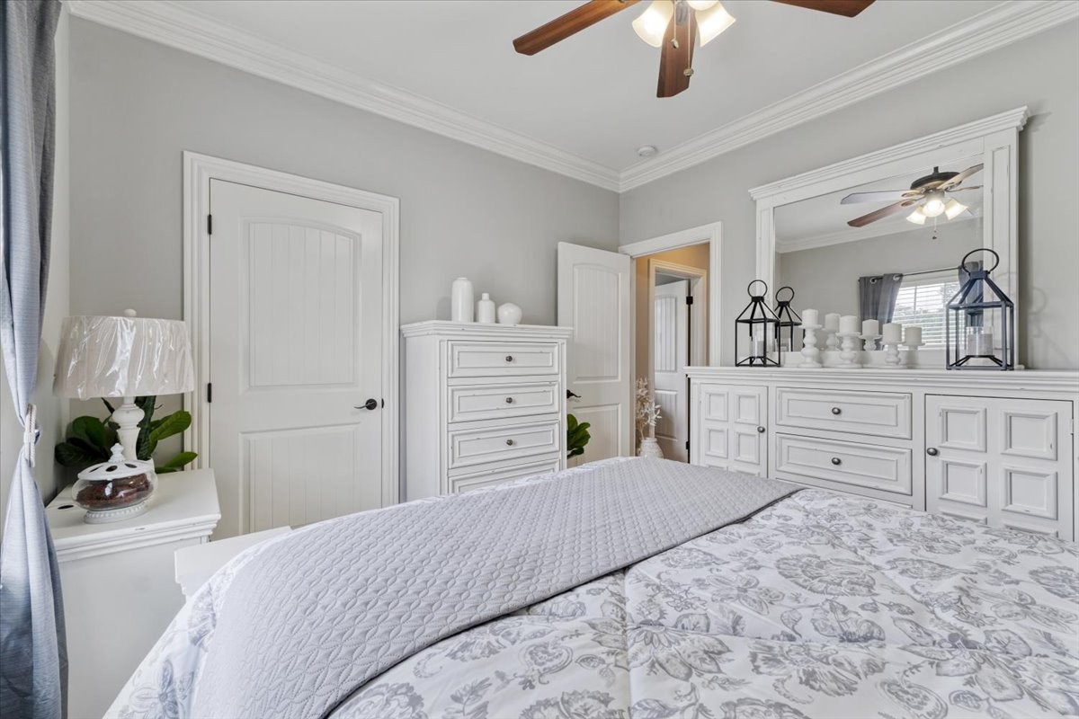 106 Riley Creek Road Tullahoma, TN 37388 - Photo 17 of 25 a bedroom with a large bed and a chandelier