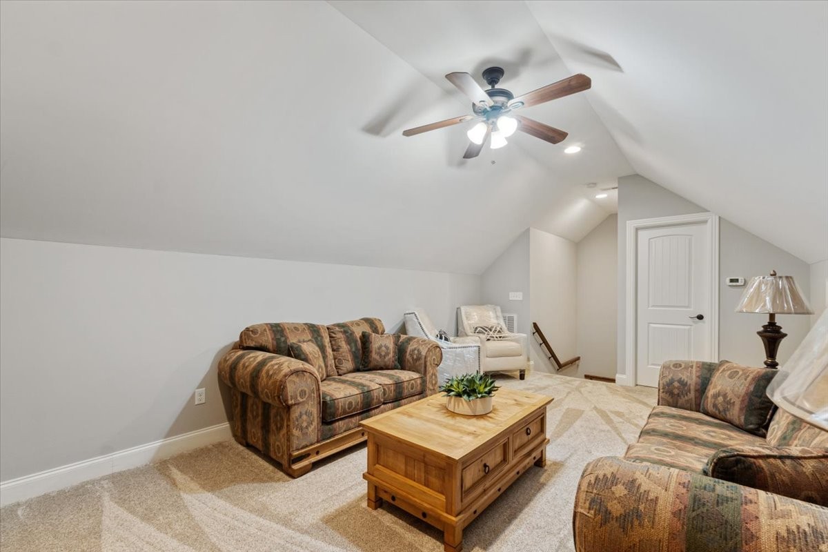 106 Riley Creek Road Tullahoma, TN 37388 - Photo 19 of 25 a living room with furniture and a chandelier